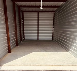 the inside of a parking garage with roll up doors